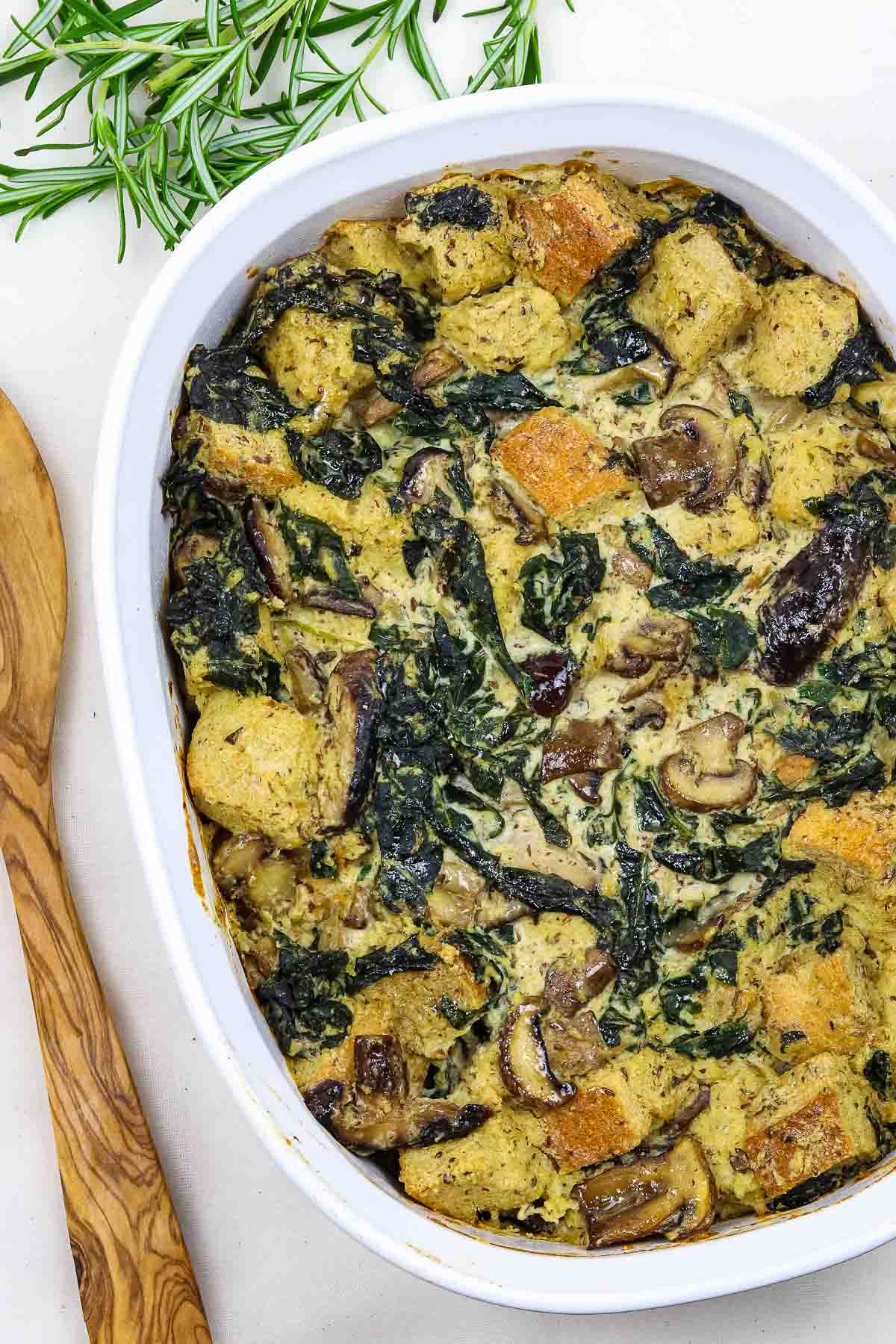 kale mushroom bread pudding in casserole dish.