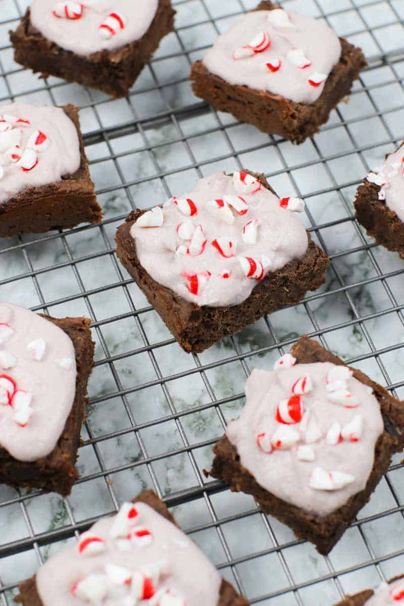 Healthy Brownies With Peppermint Frosting on a cooling rack with peppermint candies