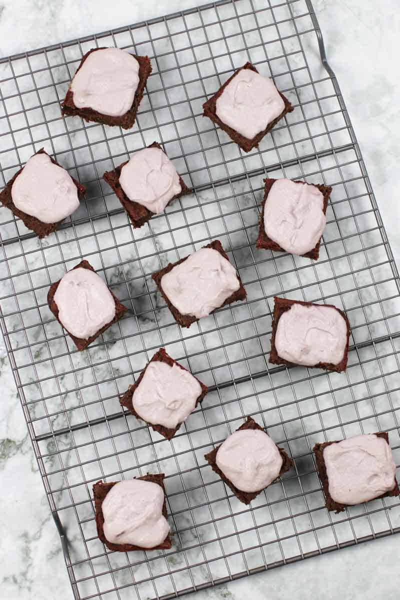 Healthy Brownies With Peppermint Frosting on a cooling rack
