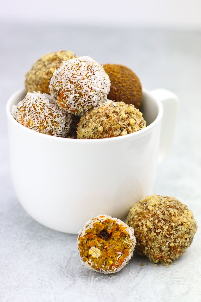 carrot cake bites in a white mug on white marble