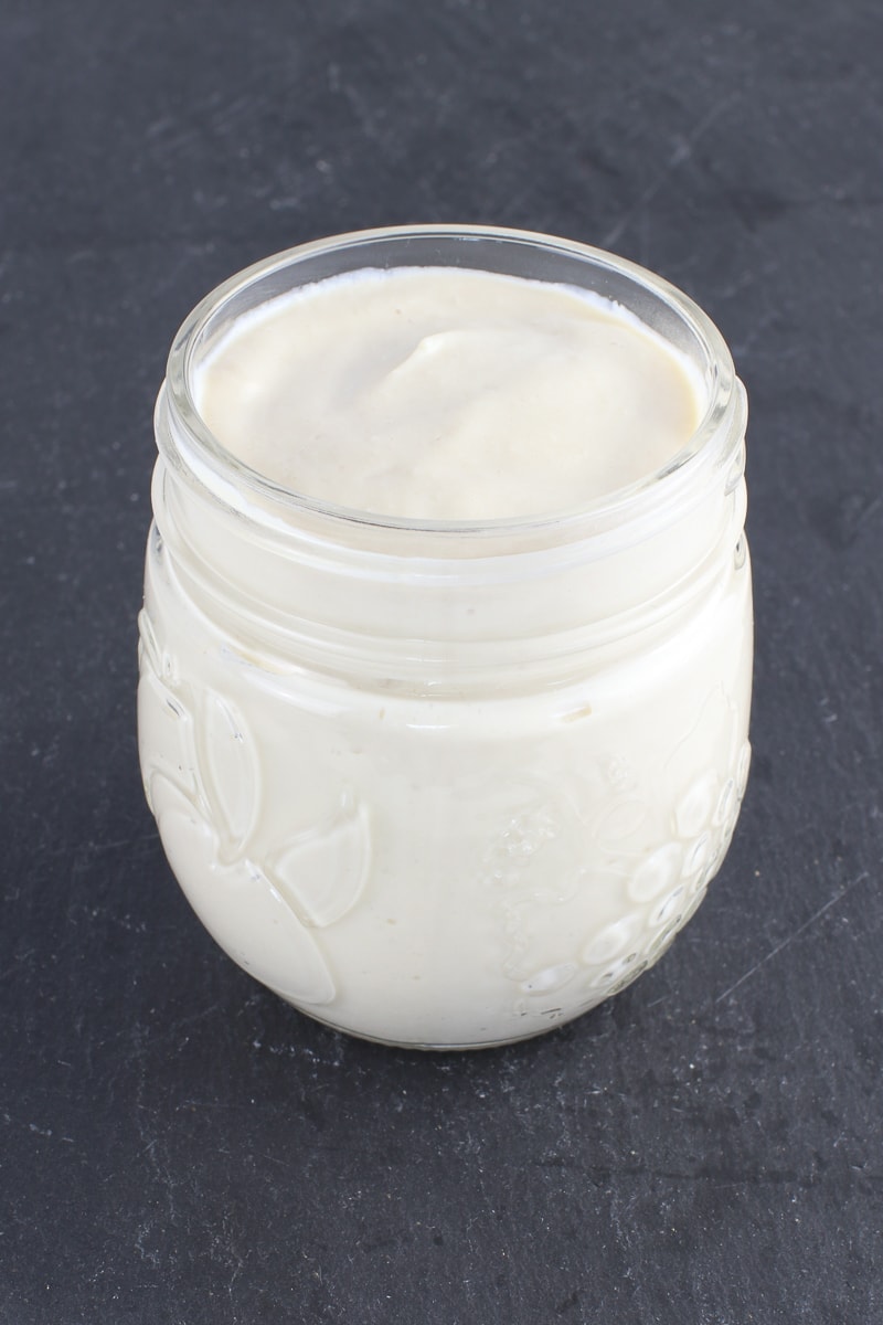 vegan oil free mayo in a jar on black slate