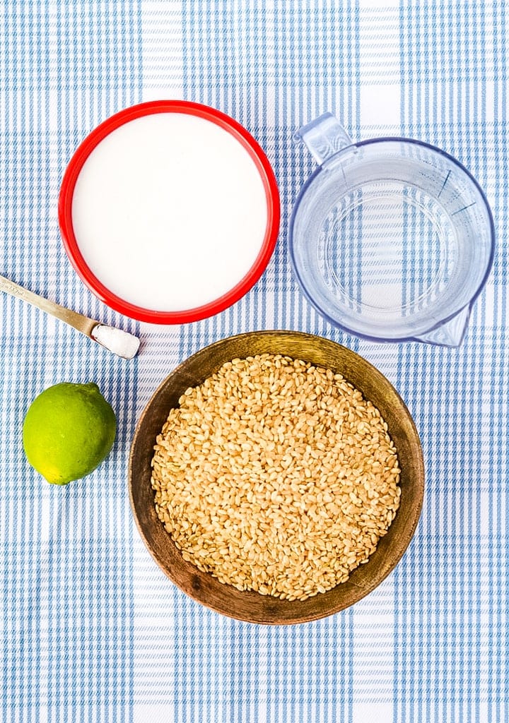 coconut lime rice ingredients, rice, coconut milk, lime, salt, on a blue plaid towel