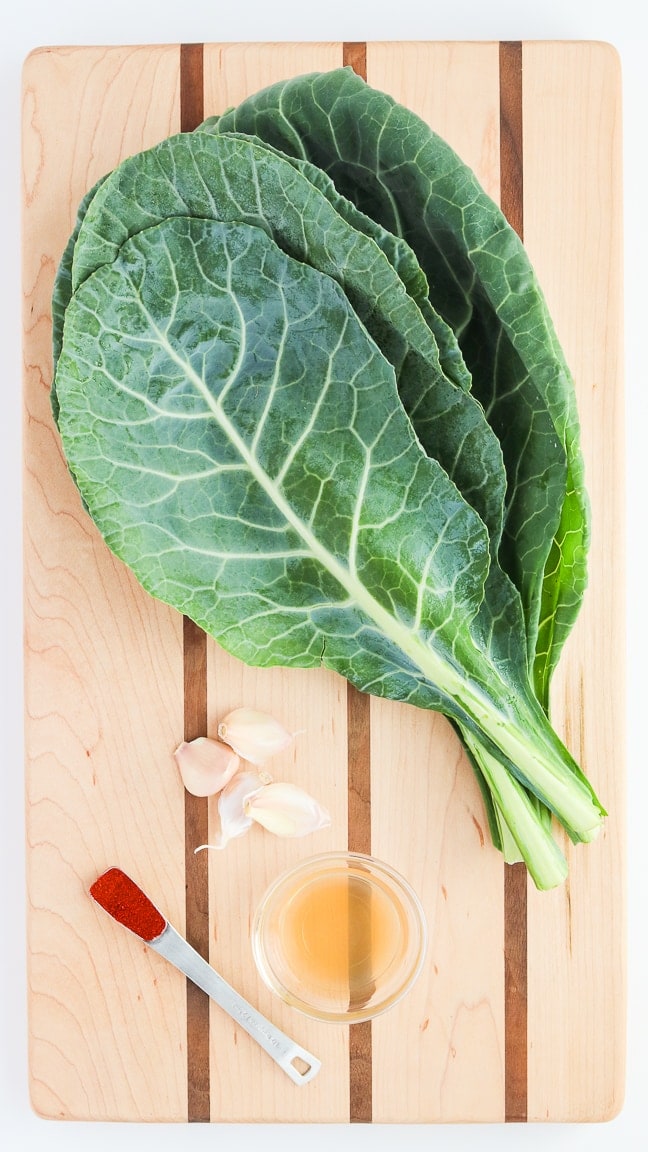 cutting board with collard greens, smoked paprika, garlic and apple cider vinegar.