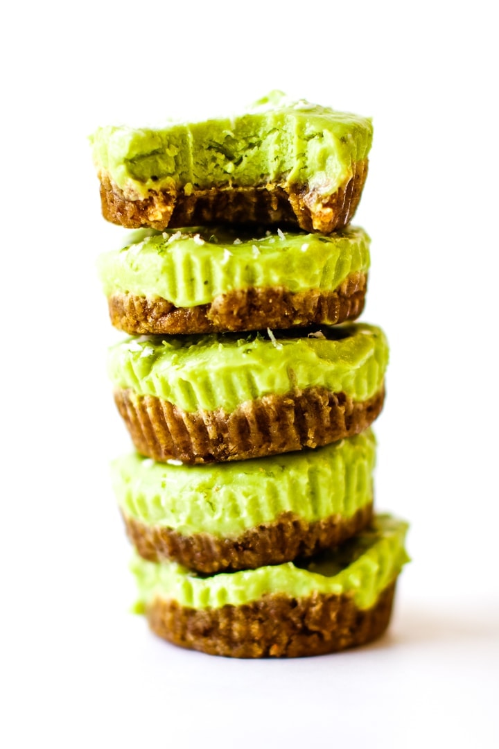 vegan key lime pie mini tarts in a stack with a bite out of top tart.