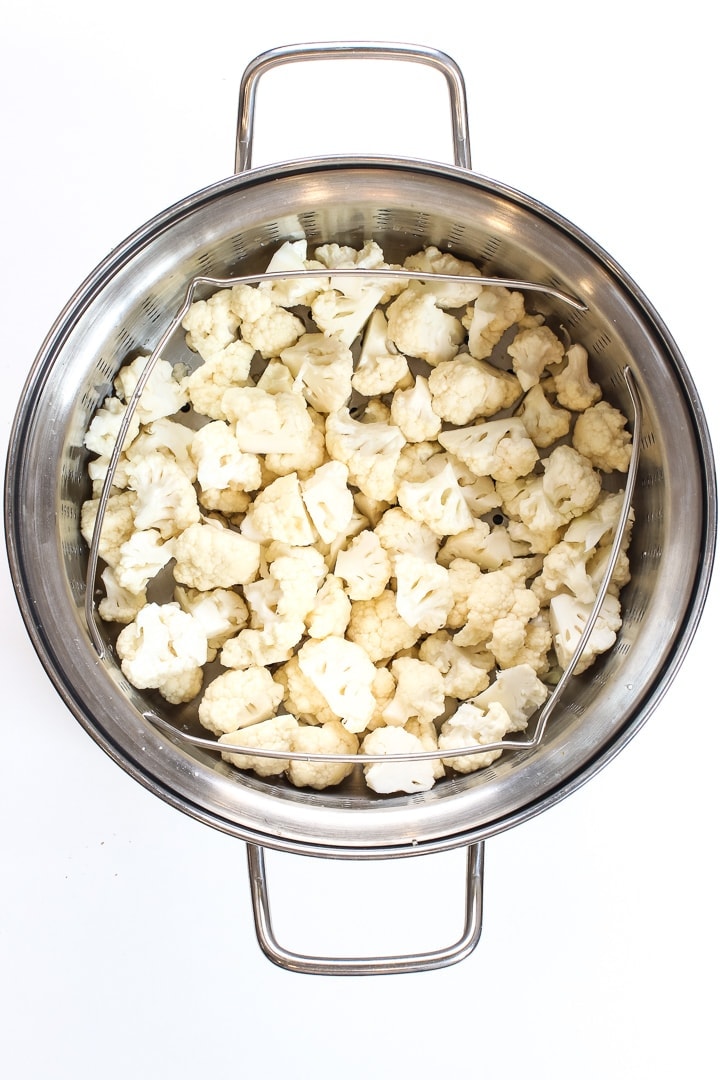 stainless steel steamer pot with cauliflower florets.