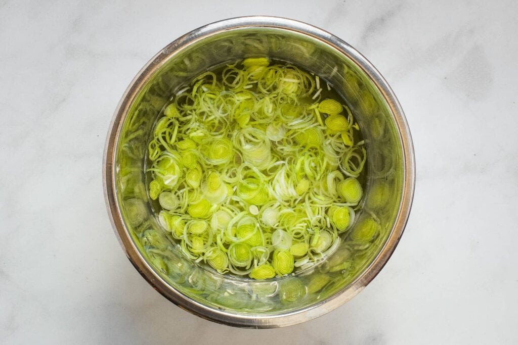 leek rings in a steel bowl filled with water