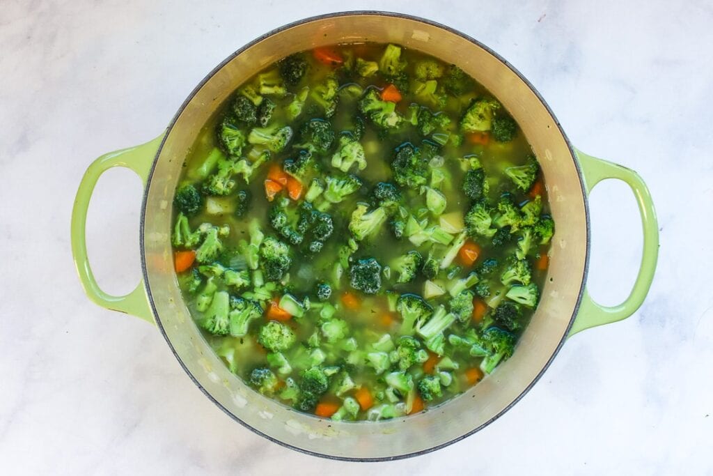 broccoli florets and broth Dutch oven with broccoli florets and broth added to veggies.