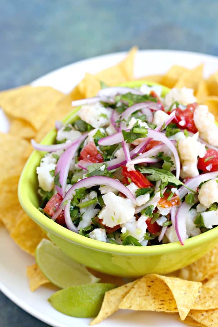 Cauliflower Ceviche in green bowl with tortilla chips 