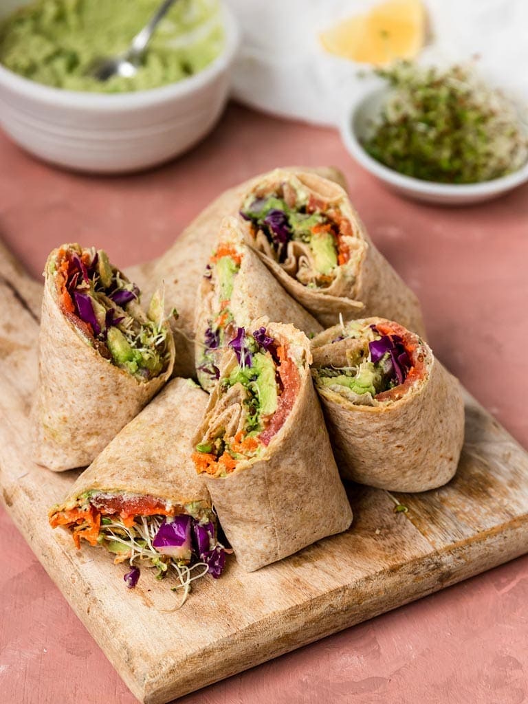 sliced Edamame Hummus Veggie Wraps on cutting board