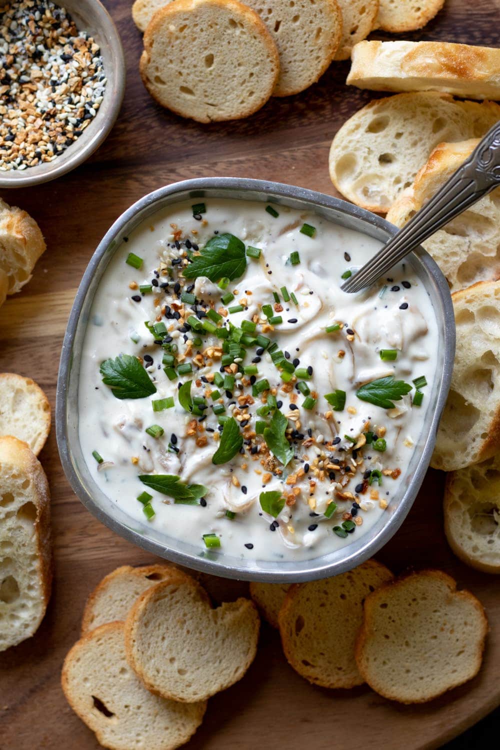 Caramelized Shallot Dip in a bowl with spoon and bread