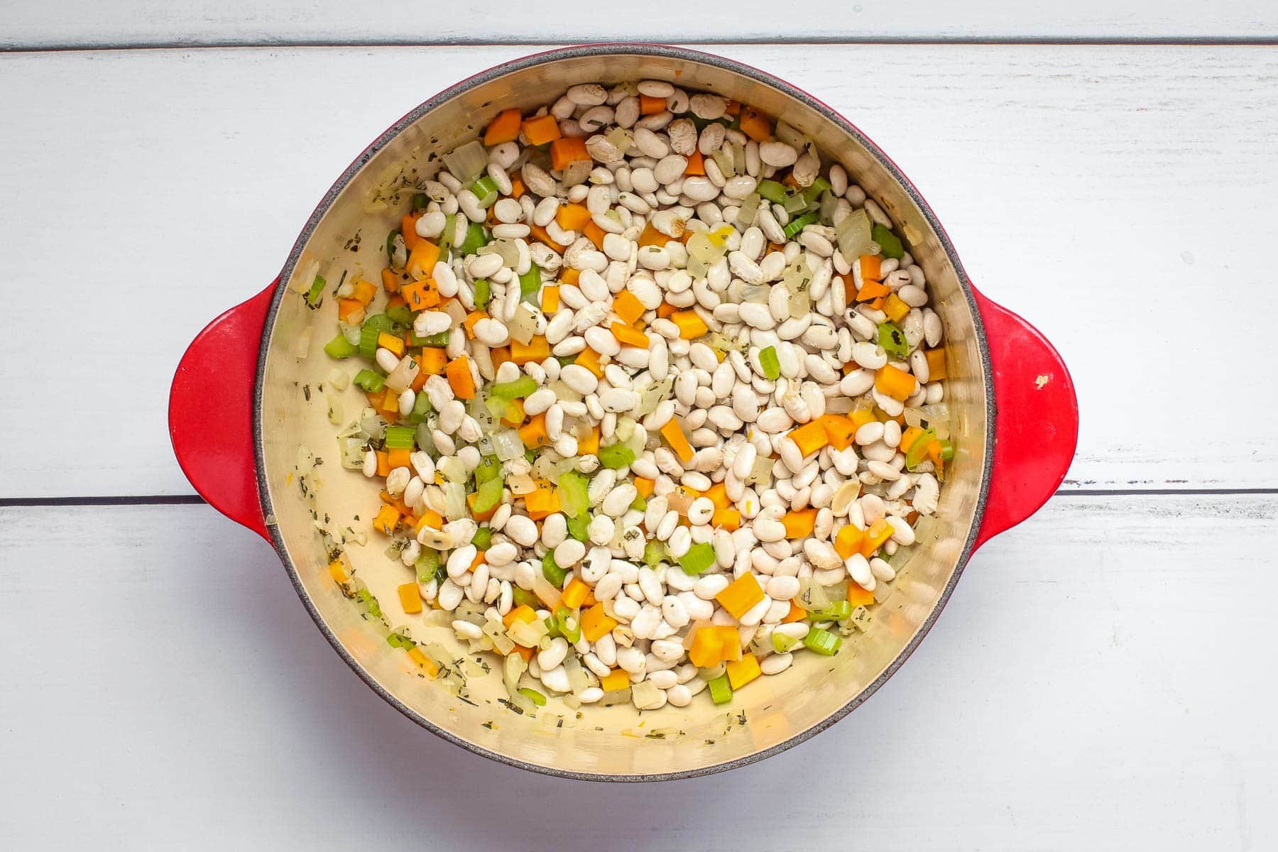 Add soaked white beans to the pot.
