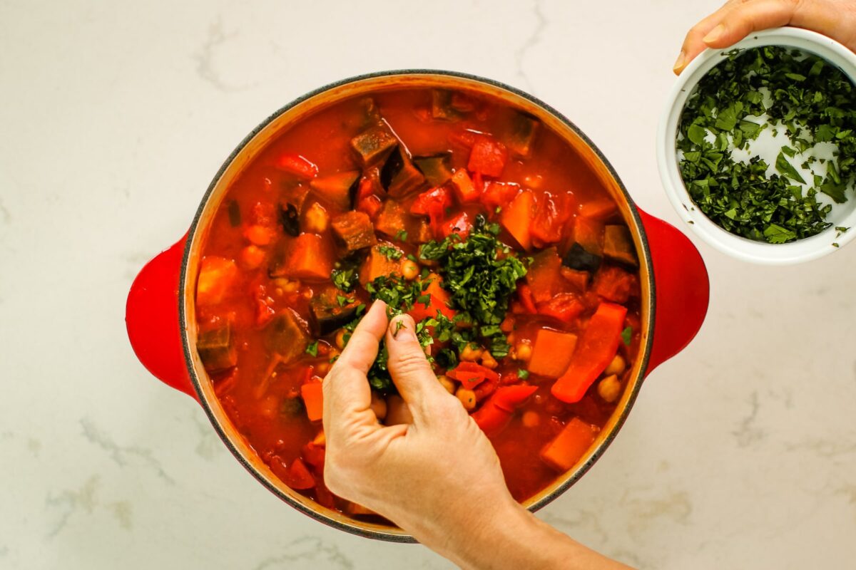 sprinkling herbs into the pot