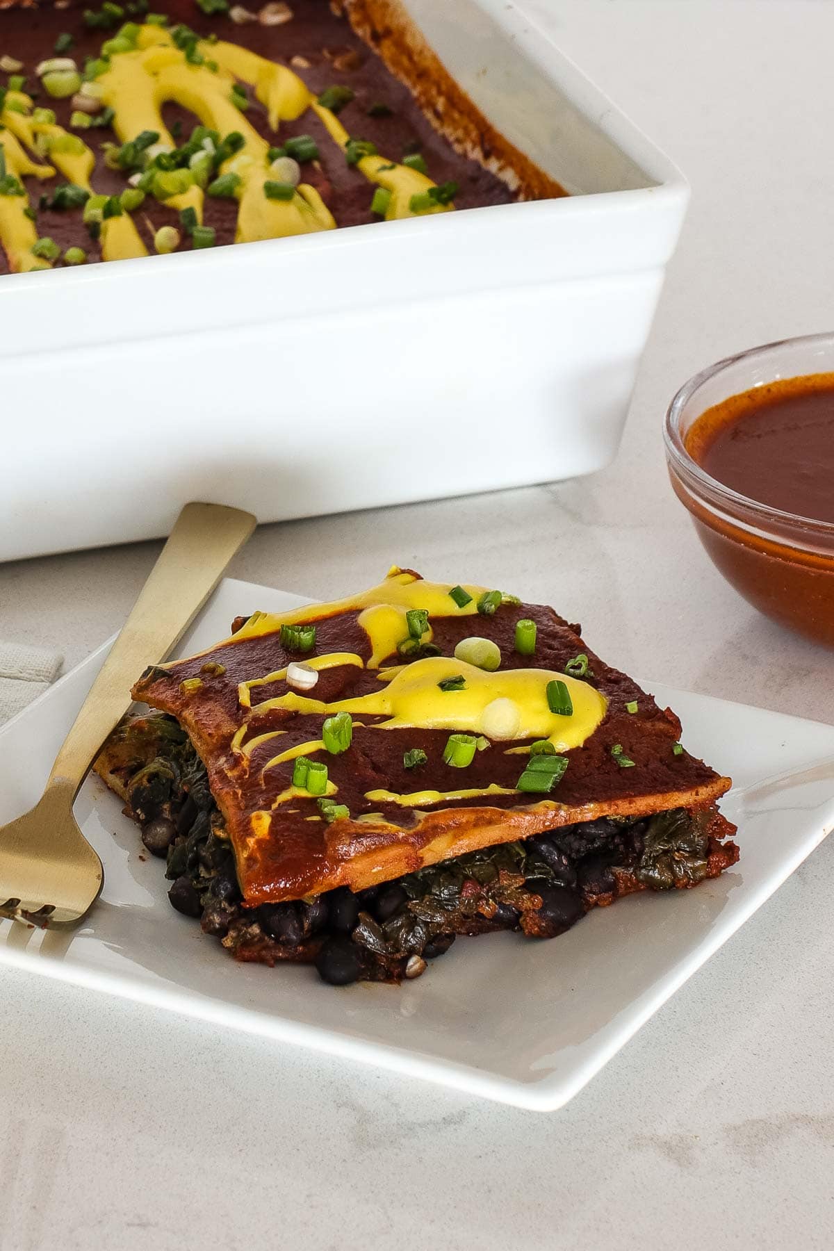 close up of piece of vegan enchilada casserole on a plate