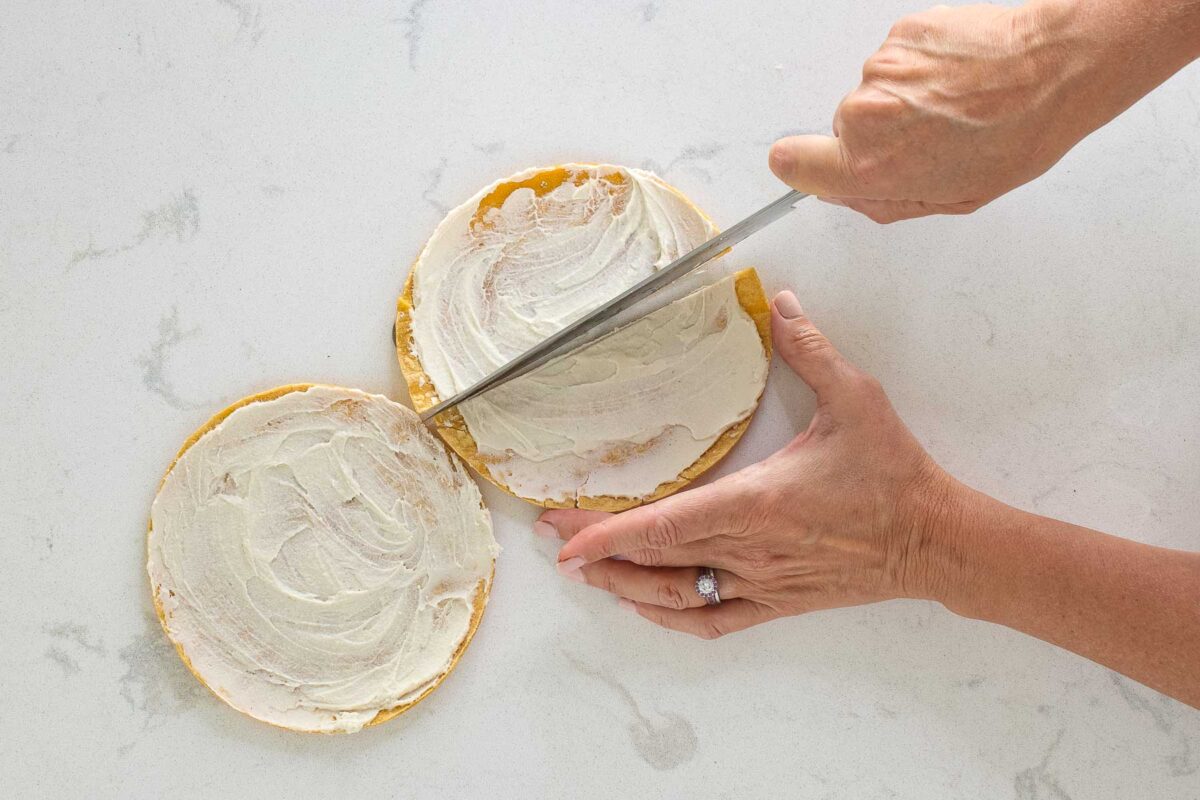 cutting cheese topped tortillas in half