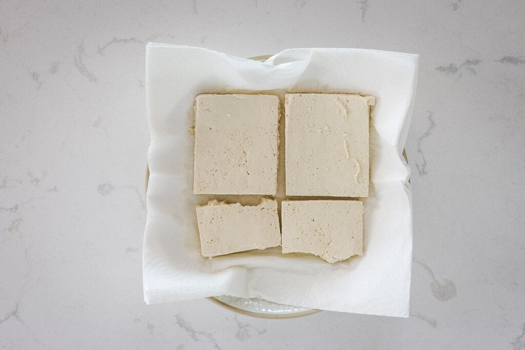 Tofu slices on paper towels.