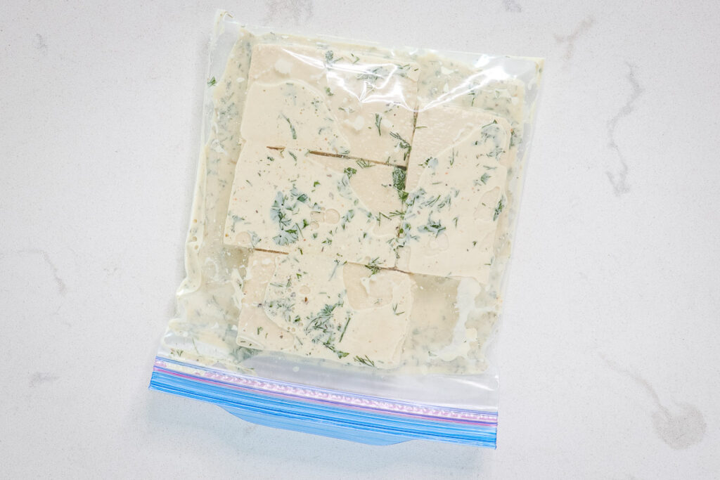 Tofu slices and marinade in a ziplock bag.