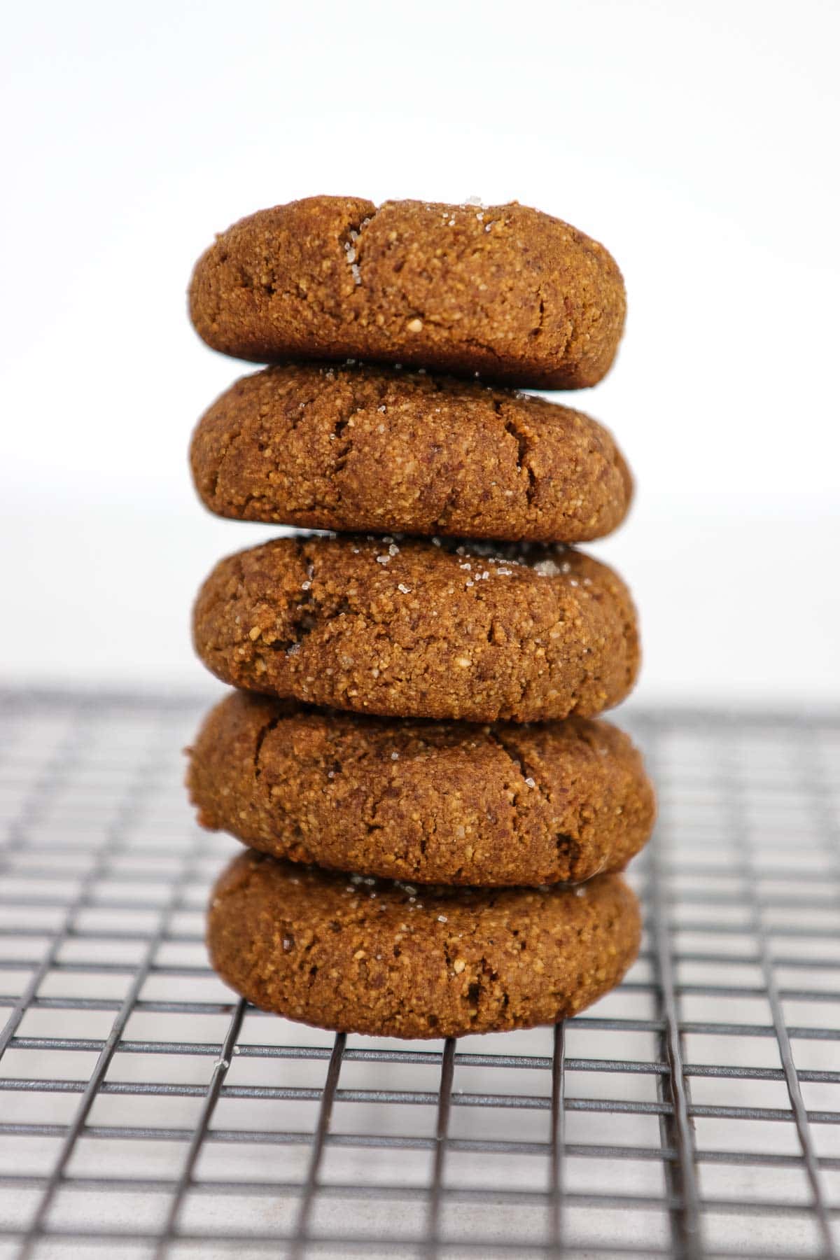 Stack of 5 cookies on a cooling rack. 