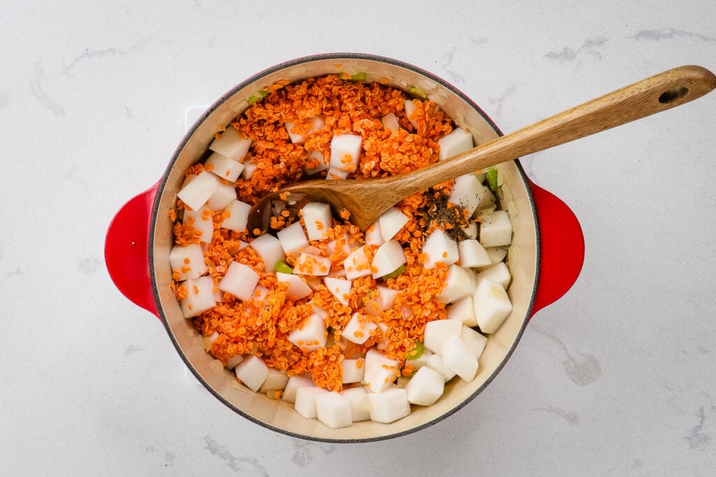 Vegetables and lentils in a Dutch oven.