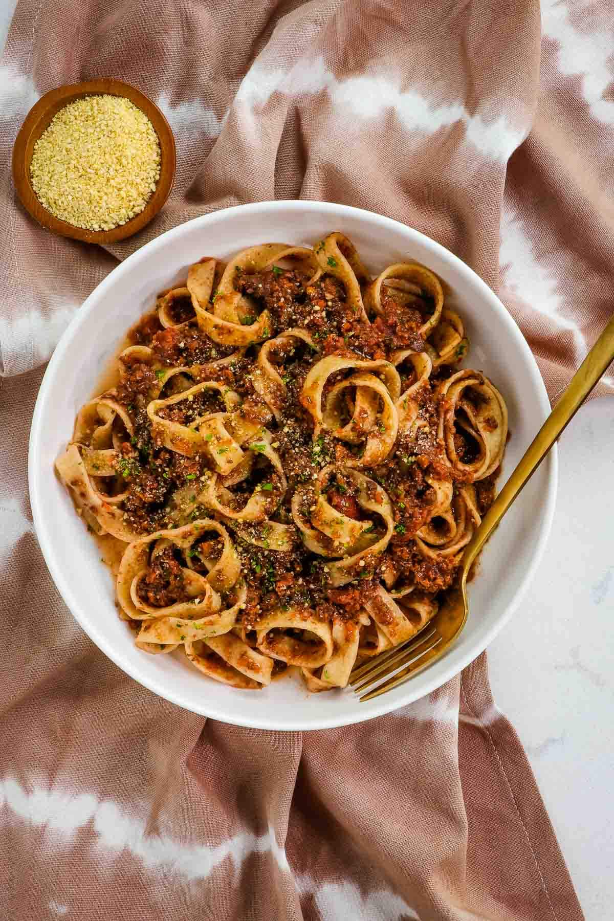 Bowl of bolognese sauce with fork. 